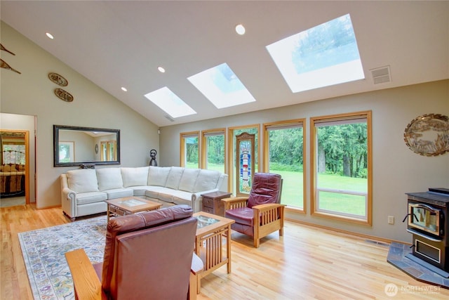 37938 Theo Ln, Concrete, WA 98237 - living room with a skylight, a wood stove, light wood-style floors, recessed lighting, and high vaulted ceiling