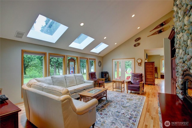 37938 Theo Ln, Concrete, WA 98237 - living room with high vaulted ceiling, a skylight, light wood-style flooring, and recessed lighting