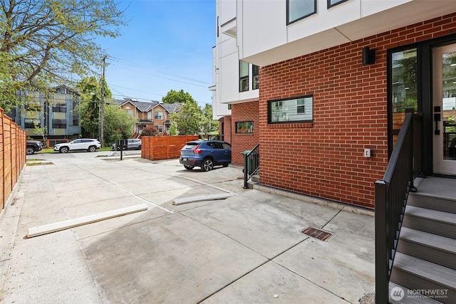 uncovered parking lot featuring fence