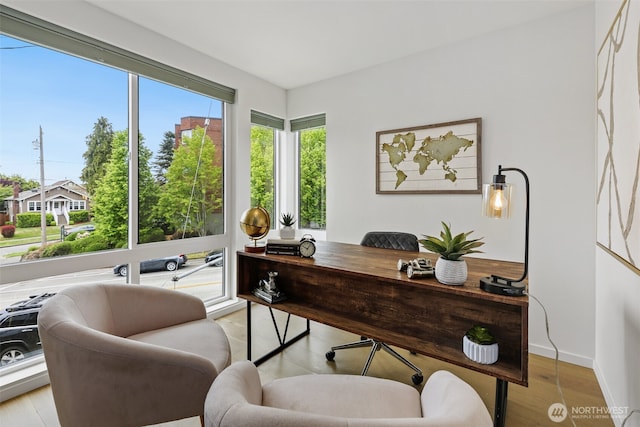 office space featuring light wood finished floors and baseboards