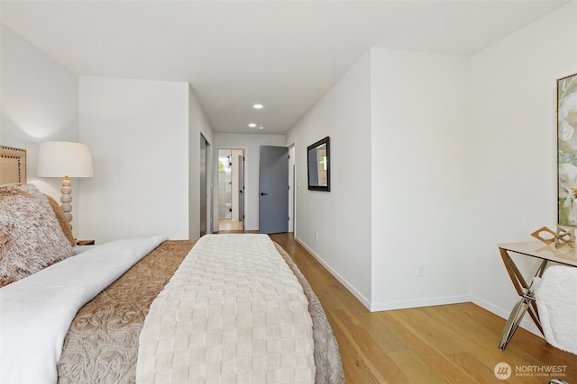bedroom featuring wood finished floors, baseboards, and recessed lighting