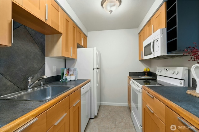 12044 96th Ave NE Unit 211, Kirkland, WA 98034 - kitchen with white appliances, a sink, baseboards, dark countertops, and brown cabinets