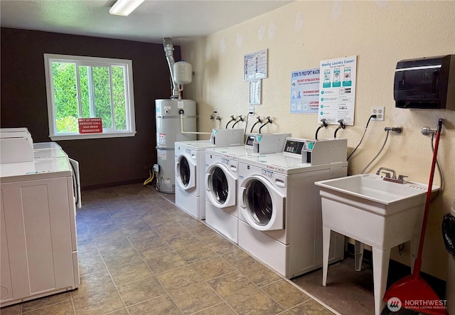 12513 NE 130th Way Unit C204, Kirkland, WA 98034 - shared laundry featuring washer and dryer, strapped water heater, and stone finish flooring