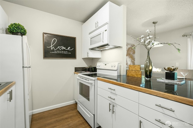 12513 NE 130th Way Unit C204, Kirkland, WA 98034 - kitchen with white appliances, dark wood-type flooring, white cabinets, baseboards, and tile counters