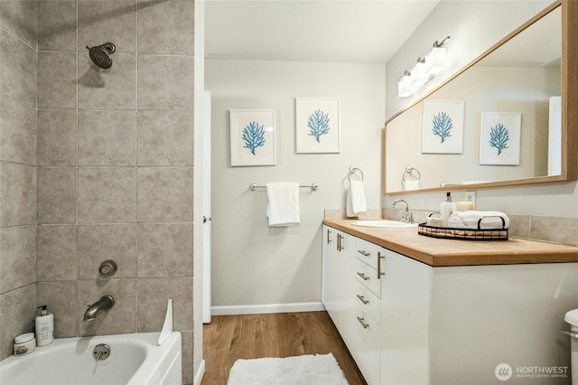 12513 NE 130th Way Unit C204, Kirkland, WA 98034 - bathroom with wood finished floors, vanity, baseboards, and washtub / shower combination