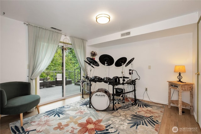 recreation room featuring wood finished floors and baseboards