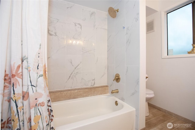 bathroom with toilet, shower / bath combo with shower curtain, and baseboards