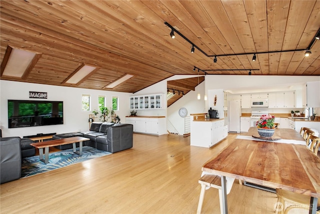 dining area featuring track lighting, wooden ceiling, light wood-type flooring, and lofted ceiling