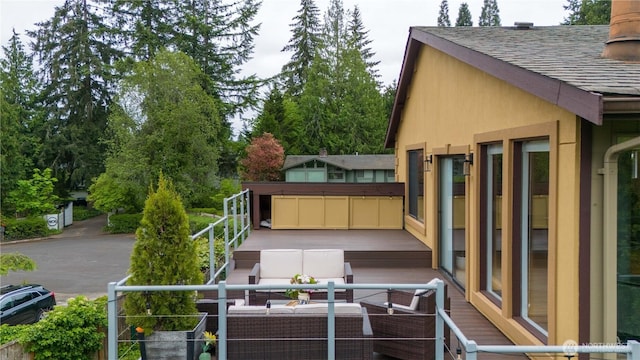 wooden terrace with an outdoor living space