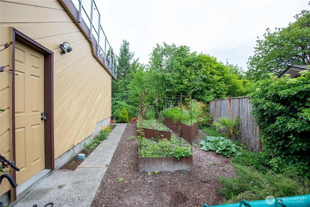 view of yard with a garden and fence