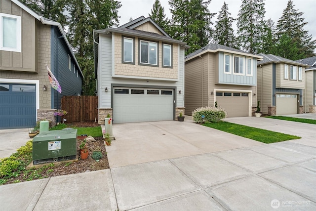7135 S 13th St, Ridgefield, WA 98642 - view of front of property featuring a garage, stone siding, and driveway