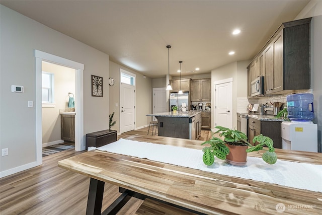 7135 S 13th St, Ridgefield, WA 98642 - dining area featuring baseboards, recessed lighting, and wood finished floors