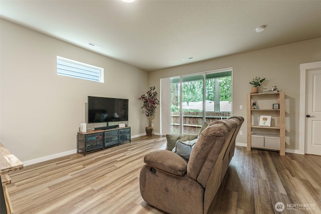 7135 S 13th St, Ridgefield, WA 98642 - living area with wood finished floors, healthy amount of natural light, and baseboards