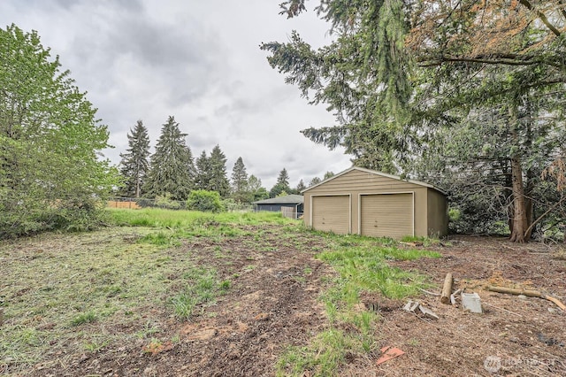 21502 38th Ave E, Spanaway, WA 98387 - view of yard with an outdoor structure and a detached garage