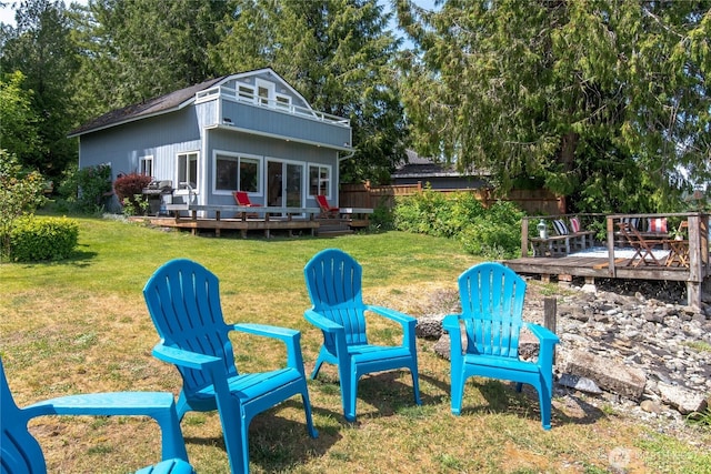 7610 E Grapeview Loop Rd, Allyn, WA 98524 - rear view of house featuring a deck and an outdoor fire pit