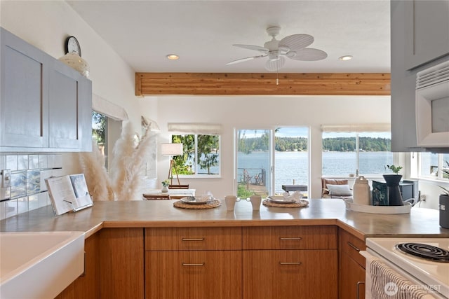 7610 E Grapeview Loop Rd, Allyn, WA 98524 - kitchen featuring plenty of natural light, a peninsula, light countertops, a ceiling fan, and recessed lighting