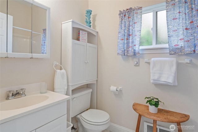 7610 E Grapeview Loop Rd, Allyn, WA 98524 - bathroom with toilet, vanity, and baseboards