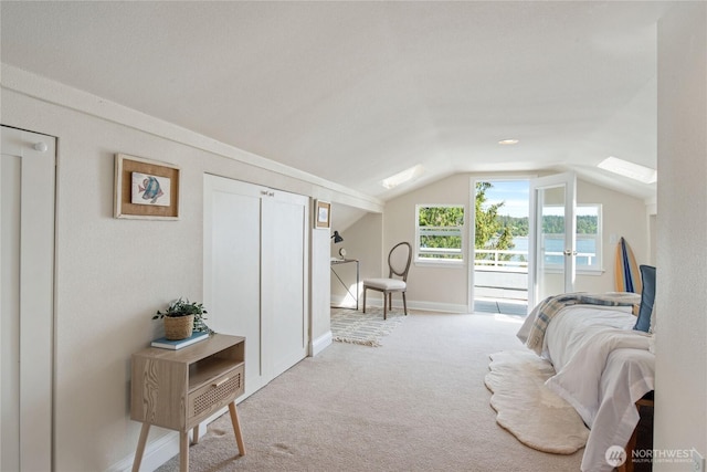 7610 E Grapeview Loop Rd, Allyn, WA 98524 - carpeted bedroom with access to outside, vaulted ceiling, baseboards, and a skylight