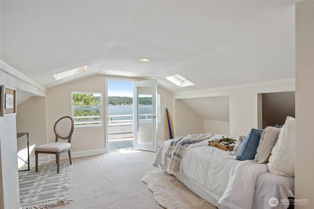 7610 E Grapeview Loop Rd, Allyn, WA 98524 - bedroom with a skylight, access to outside, carpet, lofted ceiling, and baseboards