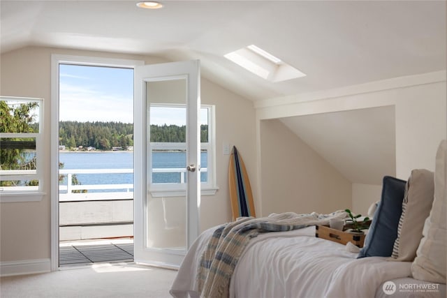 7610 E Grapeview Loop Rd, Allyn, WA 98524 - bedroom featuring lofted ceiling, a skylight, a water view, carpet, and access to outside