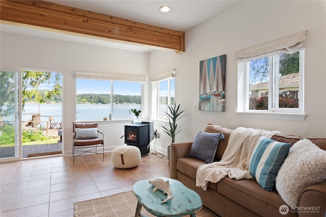 7610 E Grapeview Loop Rd, Allyn, WA 98524 - living room featuring a wood stove, healthy amount of natural light, tile patterned floors, recessed lighting, and beam ceiling