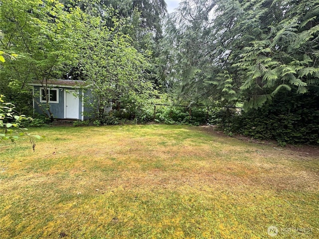 7610 E Grapeview Loop Rd, Allyn, WA 98524 - view of yard with a storage unit and an outdoor structure