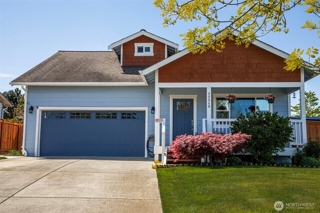 28540 74th Dr NW, Stanwood, WA 98292 - view of front of house featuring a shingled roof, a garage, concrete driveway, and a porch