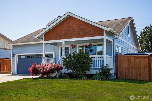28540 74th Dr NW, Stanwood, WA 98292 - view of front of house featuring covered porch, roof with shingles, a garage, and concrete driveway