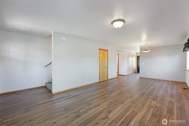 28540 74th Dr NW, Stanwood, WA 98292 - unfurnished room with wood finished floors, stairway, and baseboards