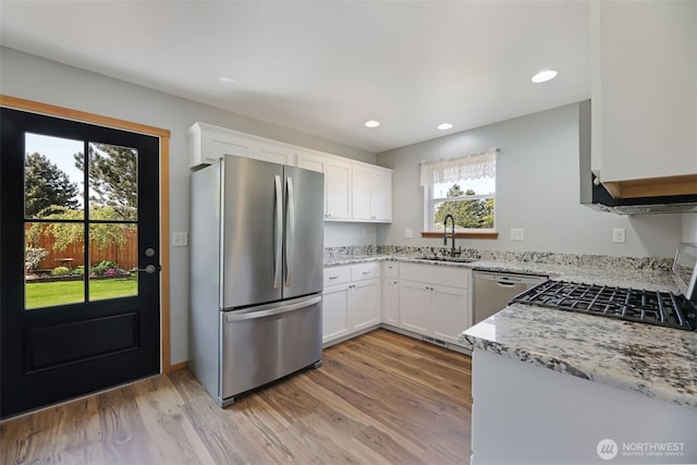 28540 74th Dr NW, Stanwood, WA 98292 - kitchen with appliances with stainless steel finishes, a sink, white cabinetry, light stone counters, and recessed lighting