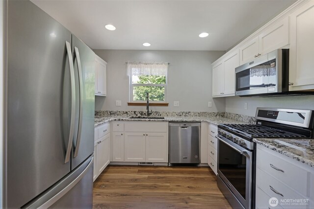 28540 74th Dr NW, Stanwood, WA 98292 - kitchen featuring stainless steel appliances, a sink, dark wood finished floors, white cabinets, and recessed lighting