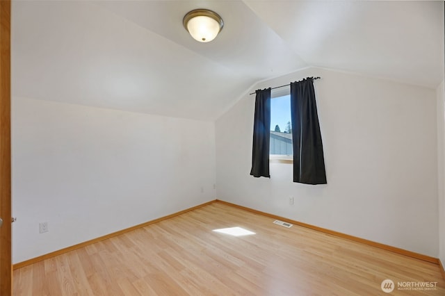 28540 74th Dr NW, Stanwood, WA 98292 - additional living space with wood finished floors, vaulted ceiling, and baseboards