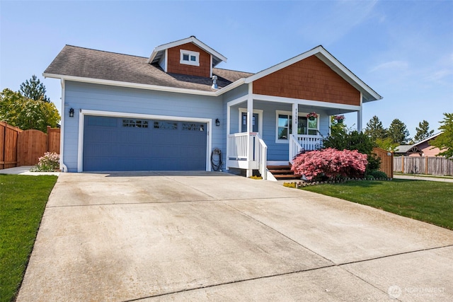 28540 74th Dr NW, Stanwood, WA 98292 - view of front of house featuring covered porch, a garage, concrete driveway, and a shingled roof