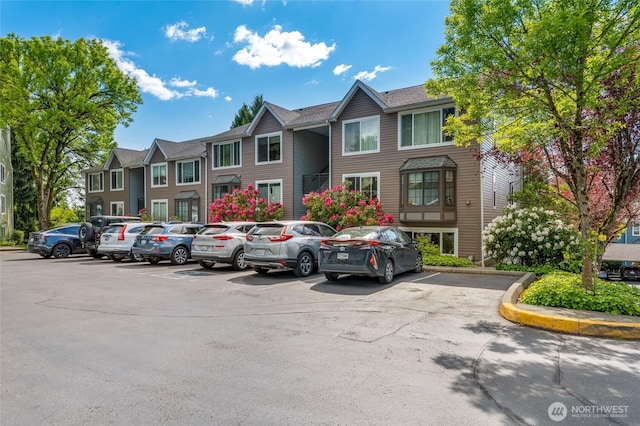 12724 NE 144th St Unit E-104, Kirkland, WA 98034 - uncovered parking lot featuring a residential view
