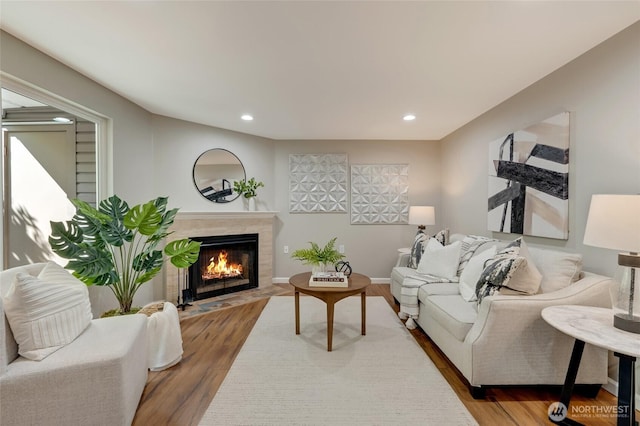 12724 NE 144th St Unit E-104, Kirkland, WA 98034 - living room featuring a high end fireplace, wood finished floors, and recessed lighting