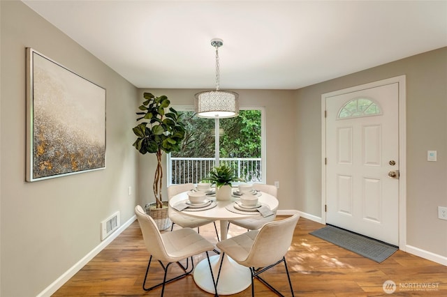 12724 NE 144th St Unit E-104, Kirkland, WA 98034 - dining space featuring baseboards and wood finished floors