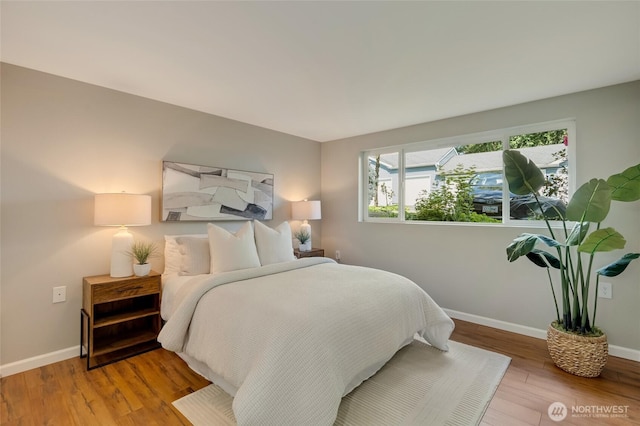 12724 NE 144th St Unit E-104, Kirkland, WA 98034 - bedroom with light wood-type flooring and baseboards