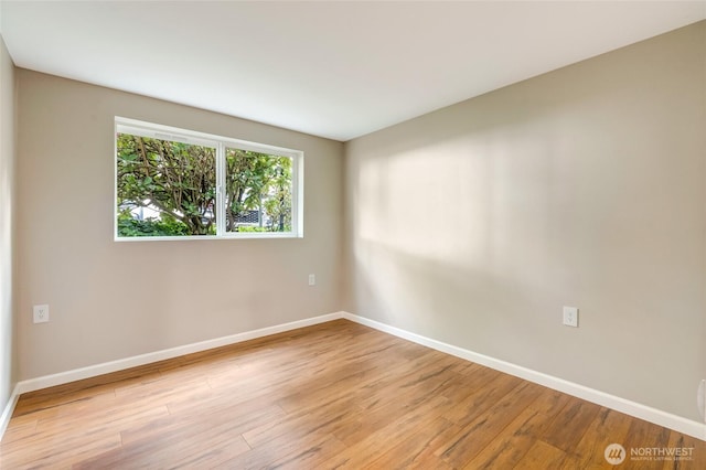 12724 NE 144th St Unit E-104, Kirkland, WA 98034 - empty room with baseboards and light wood-style flooring