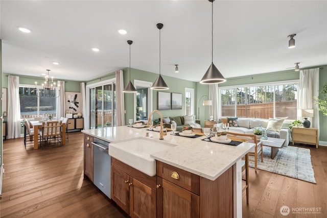 14652 203rd Ave E Unit 15, Bonney Lake, WA 98391 - kitchen featuring open floor plan, a sink, stainless steel dishwasher, dark wood-style floors, and plenty of natural light