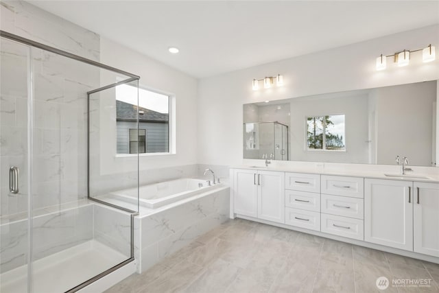 14664 203rd Ave E Unit 12, Bonney Lake, WA 98391 - bathroom featuring a marble finish shower, a garden tub, double vanity, healthy amount of natural light, and recessed lighting