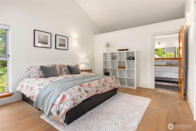 10611 NE 155th Pl, Bothell, WA 98011 - bedroom featuring wood finished floors, vaulted ceiling, and baseboards
