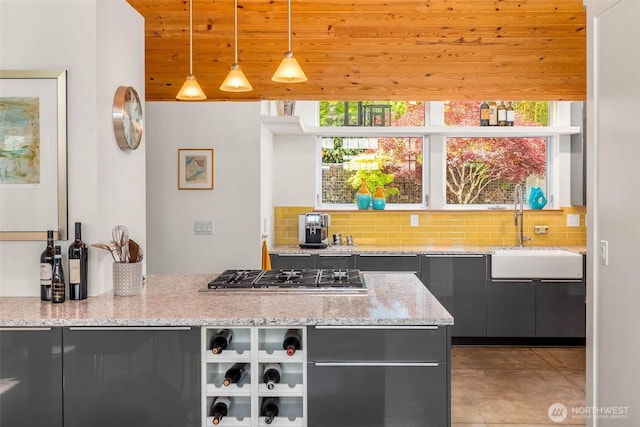 10611 NE 155th Pl, Bothell, WA 98011 - kitchen featuring stainless steel gas stovetop, a sink, backsplash, light stone counters, and wooden ceiling