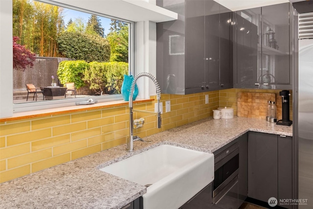 10611 NE 155th Pl, Bothell, WA 98011 - kitchen with a sink, backsplash, light stone countertops, and stainless steel microwave