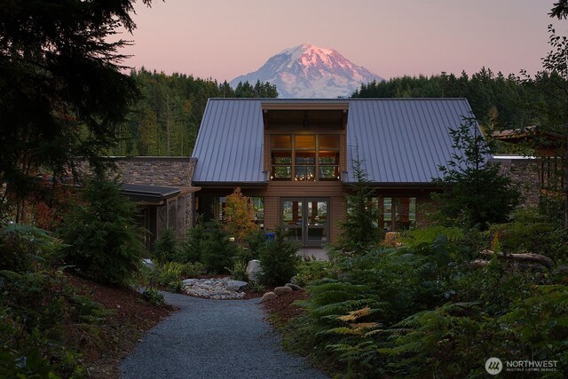 14636 203rd Ave E Unit 19, Bonney Lake, WA 98391 - view of front of house featuring a mountain view, french doors, and metal roof