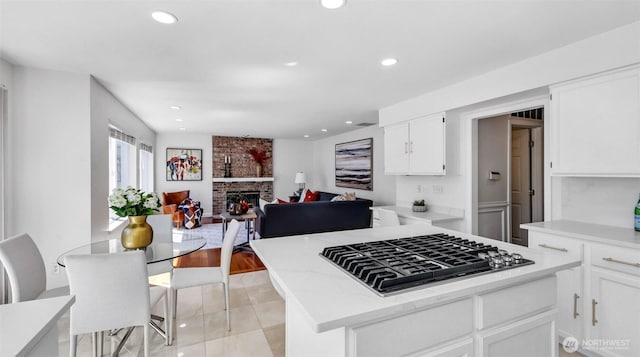 1734 Ilwaco Ave NE, Renton, WA 98059 - kitchen with stainless steel gas cooktop, open floor plan, white cabinets, a center island, and recessed lighting