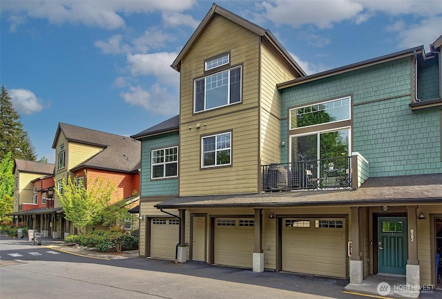 multi unit property with a garage and a balcony