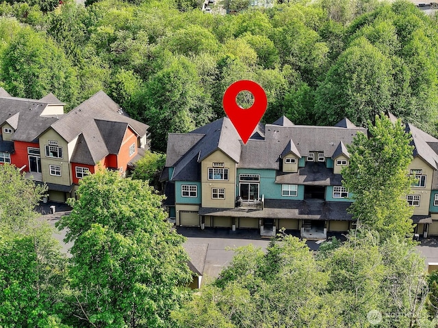 aerial perspective of suburban area with a heavily wooded area