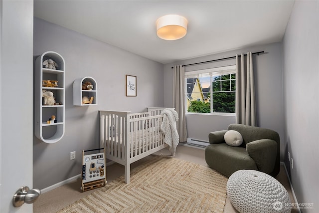 carpeted bedroom featuring a baseboard heating unit, a crib, and baseboards