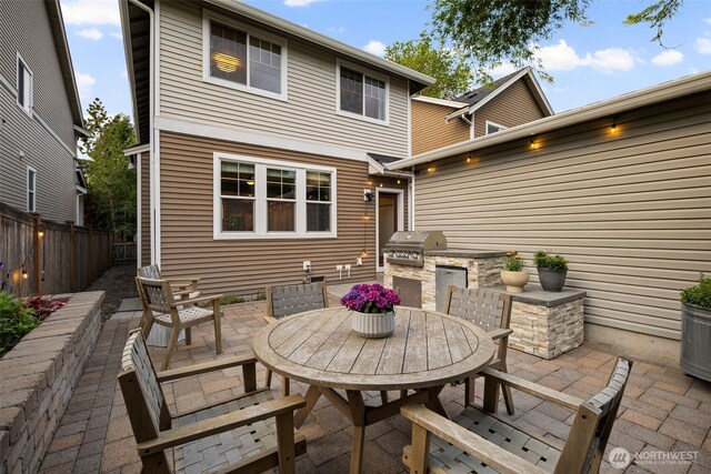view of patio / terrace featuring exterior kitchen, area for grilling, and outdoor dining space