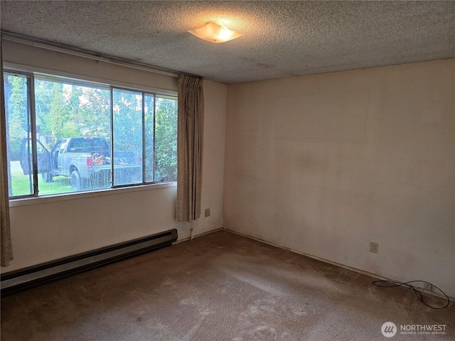 carpeted spare room with baseboard heating and a textured ceiling